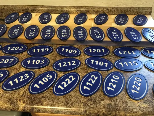 Blue oval apartment address number plaques