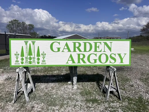 Garden Argosy custom routed sign with green lettering and garden tool graphics